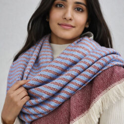 close-up of handwoven maroon and blue shawl